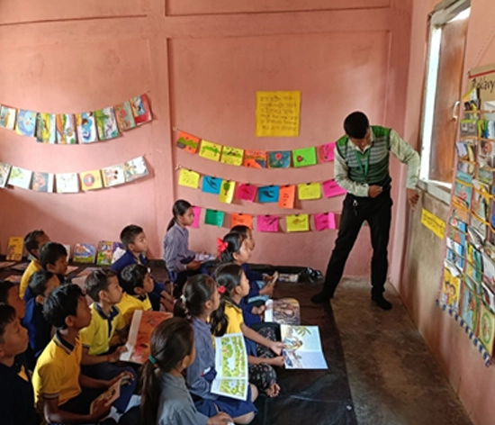 A print-rich classroom at Bhaishkhuli LP School, Goalpara, where teachers use storybooks and visual aids to enhance learning.