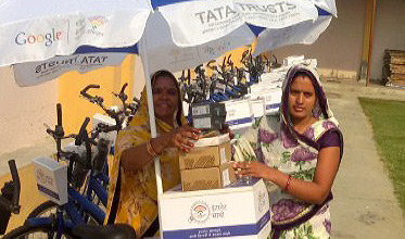 An internet saathi takes possession of her cycle cart, umbrella and other accessories