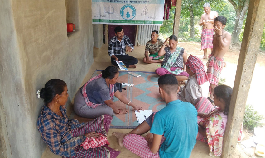 Water user committee president Abhinanda Debbarma (in check shirt) leads a water tariff collection initiative in Panbua village in the Dhalai district of Tripura.