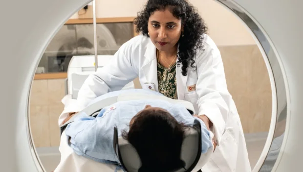 Doctor preparing a patient for a cancer diagnostic scan