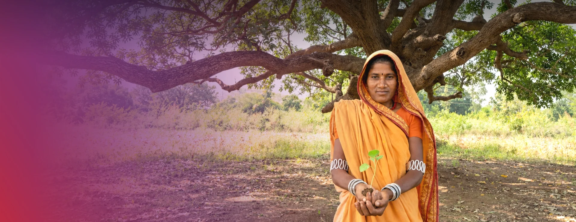 Woman holding a seedling for community development