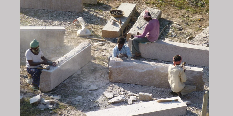 Stone-craftsmen hand cut and dress large granite stones using original tools and techniques